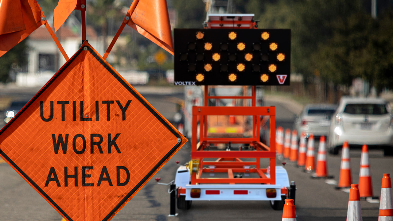 utility work ahead daytime photo with arrow board